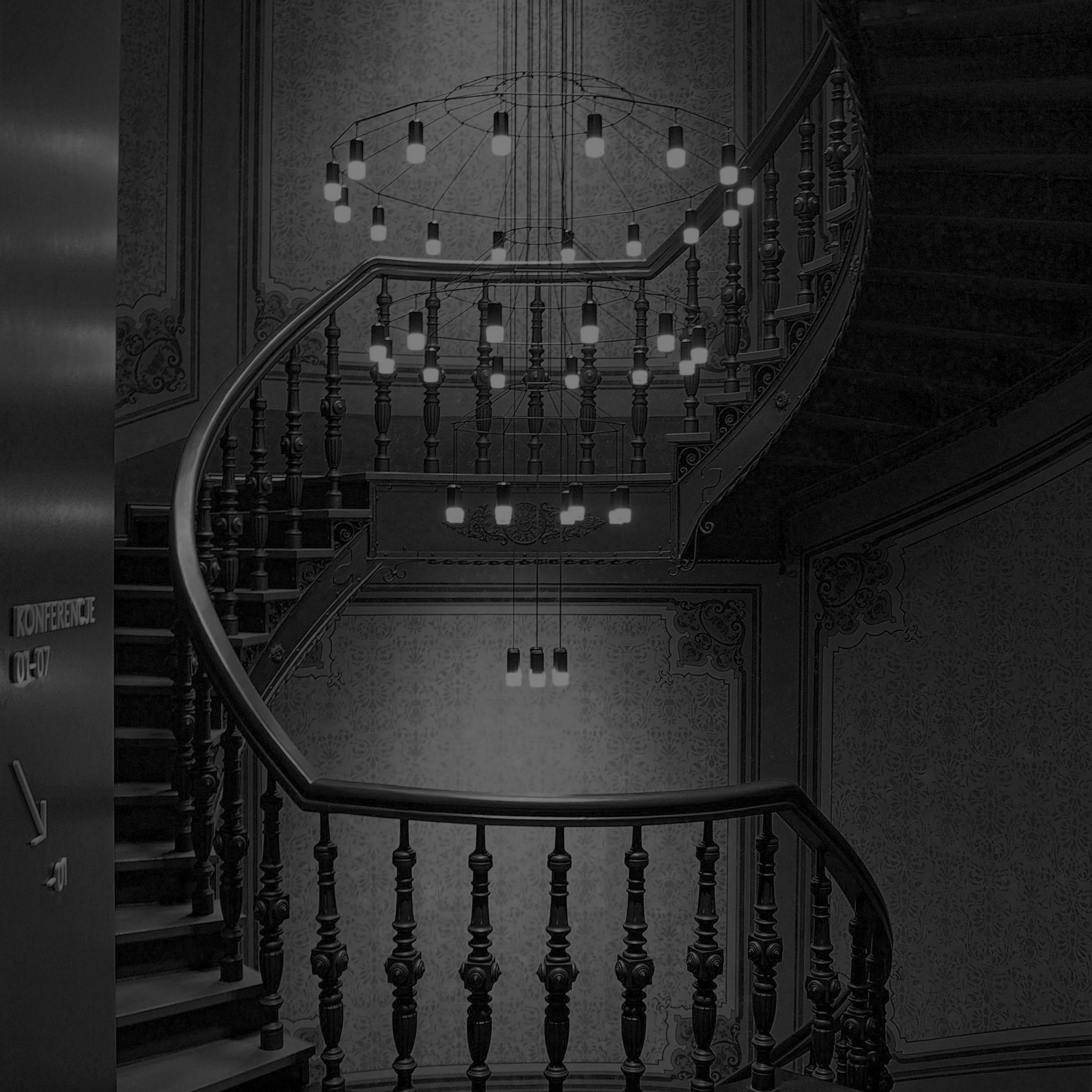 A dark image of a spiral staircase in a premium hotel