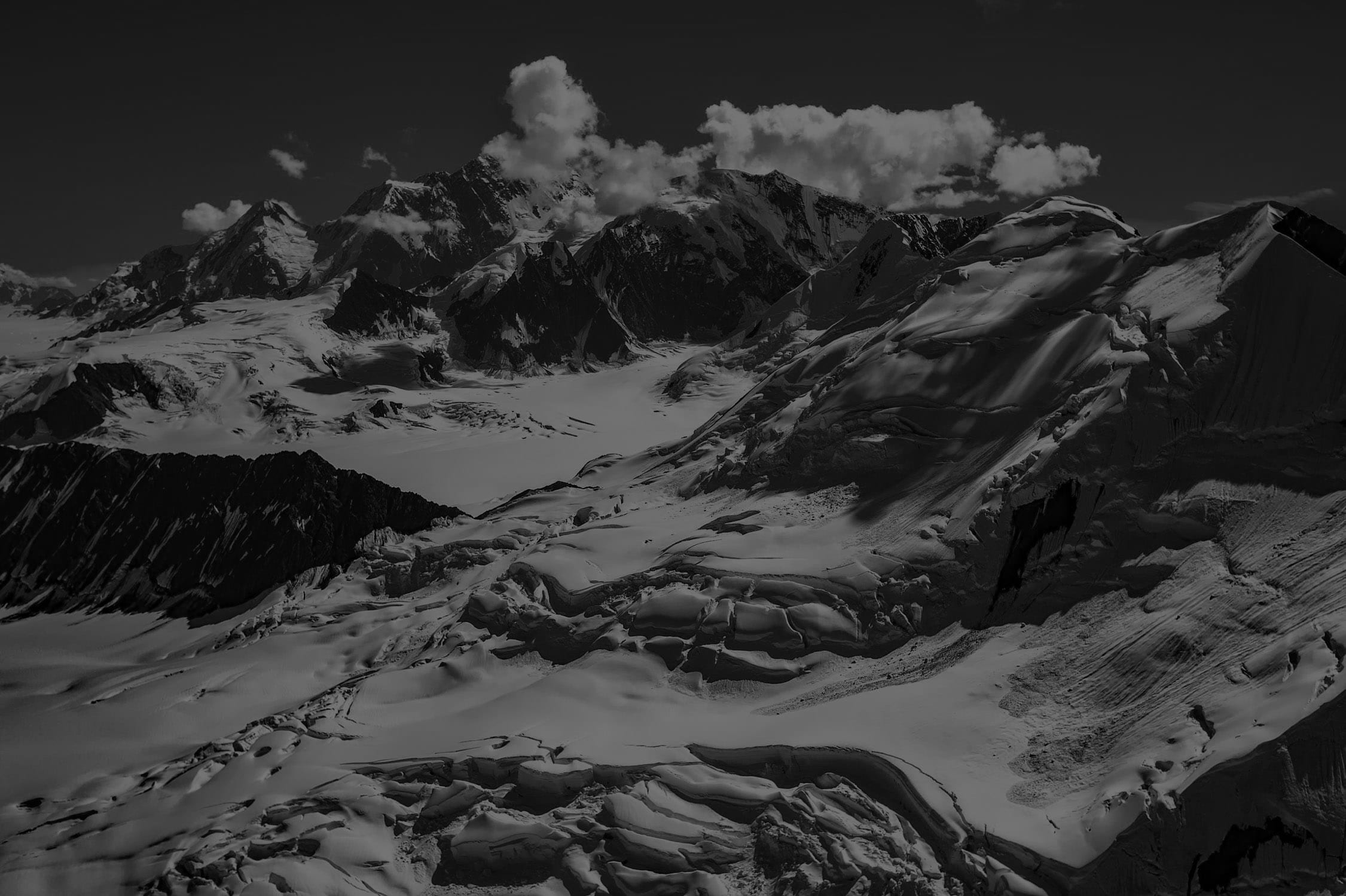 Black and white image of mountains and snow