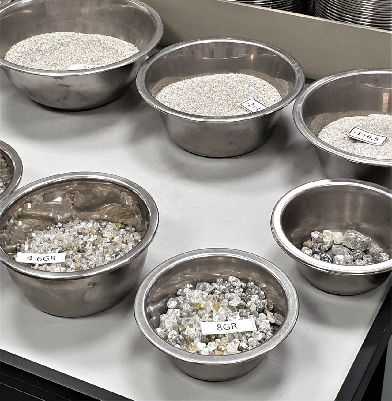 Rough diamonds being sorted by weight and size