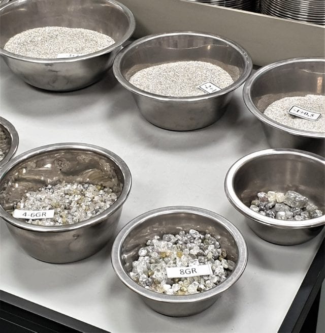 Rough diamonds being sorted by weight and size